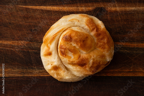 Obraz na plátně Burek, a typical Balkan baked product made with thin layers of puff pastry and a cheese filling