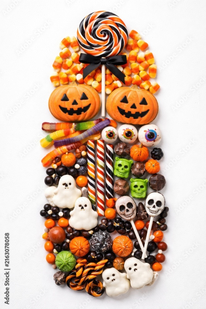Fototapeta premium Halloween candy collection with pumpkin ghost skull and lollipop treats on white background
