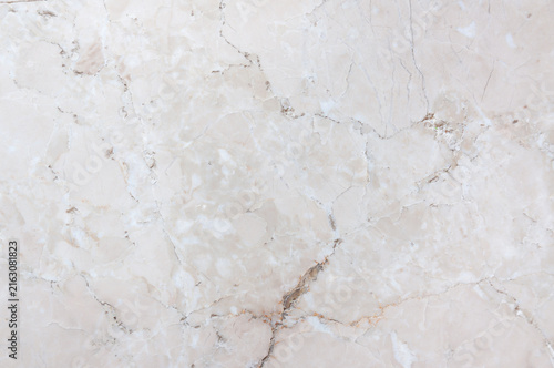 Close-up texture of natural polished white marble stone surface with elegant beige veins and cracks
