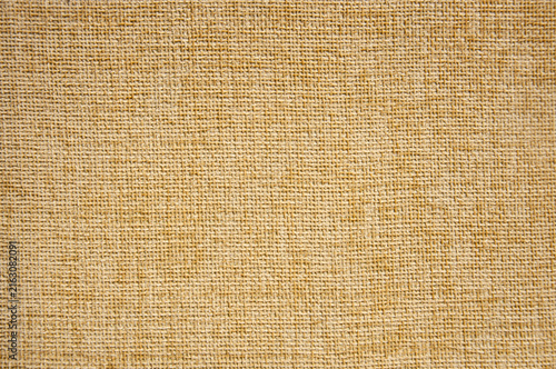 Close-up texture of a rough beige burlap canvas or rustic linen fabric cloth, abstract textile background