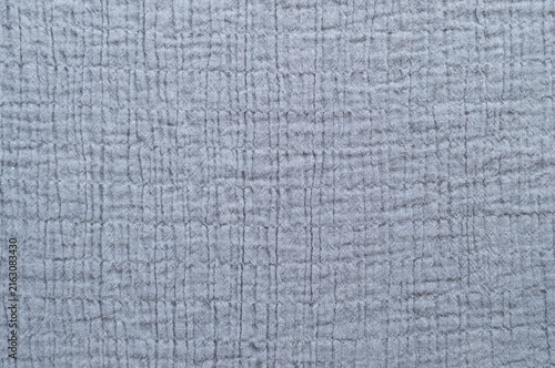 Close-up texture of grey muslin cotton fabric, abstract soft wrinkled textile background