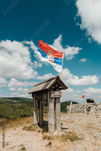 Canvastavla A Serbian flag flies above a wooden bell structure at Nebeske Stolice on Kopaonik, Serbia