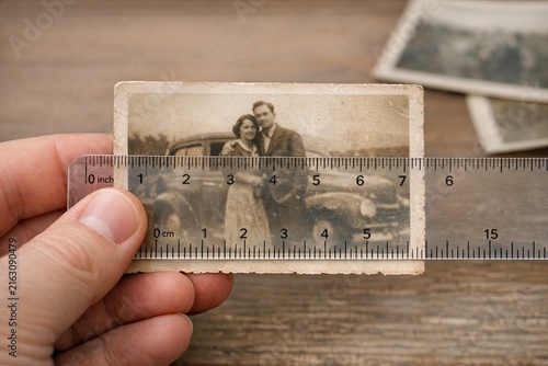 A couple holds a ruler together, likely used for measuring or drawing