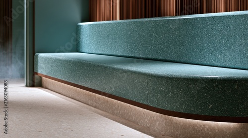 Modern teal upholstered bench with wooden trim and ambient lighting