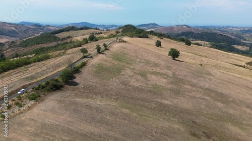 Europe, Italy, Lombardy, Pavia, Montù Berchielli – drone view of the Oltrepò Pavese hills; drought and water shortages lead to an early grape harvest for wine production. Global warming and climate ch