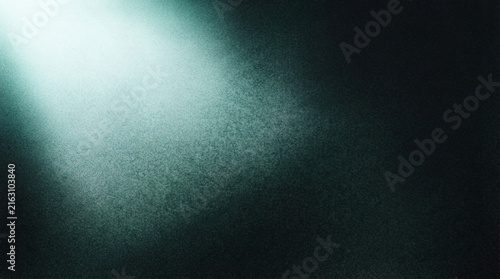 Spotlight Beam Shining From The Top Corner Onto A Gritty Dark Teal Textured Background
