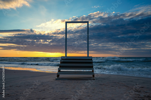Open door and stairs access to the sea and sky. Concept image
