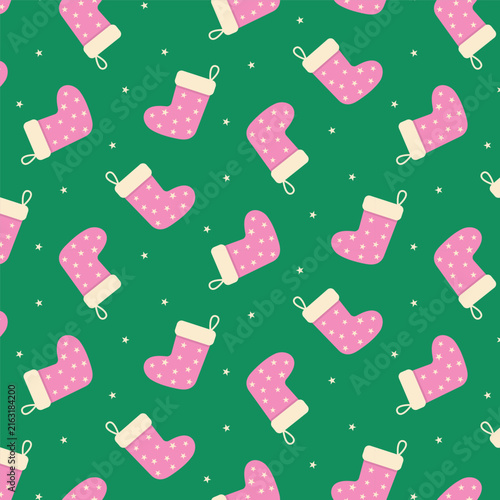 Cute Christmas seamless pattern.Pink stocking and stars repeat pattern isolated on green background.
