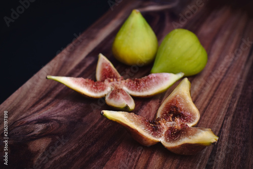Closeup of fresh green figs sliced served on a charcuterie board