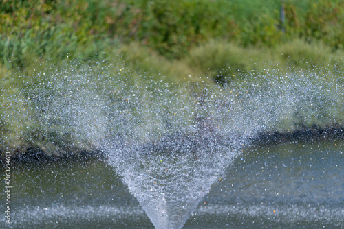 Foto Water fountain dancing gracefully in the sunlight creating sparkling droplets ab