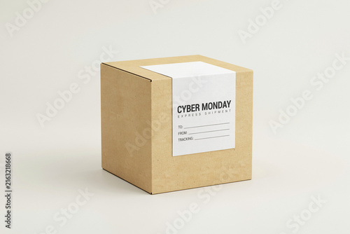 Cyber Monday cardboard shipping box with white label. Brown paper parcel for online shopping delivery. Minimalist retail package.