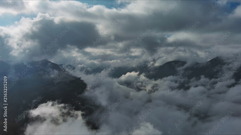 Fototapeta premium Aerial high view of dramatic clouds and sun