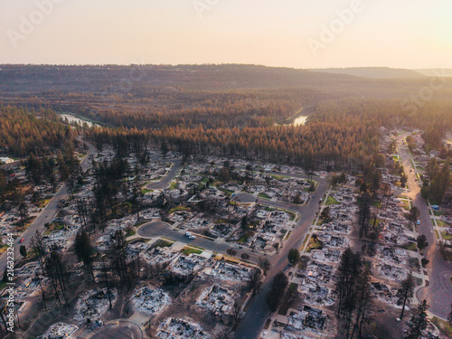 Aerial view of charred remains of residential houses and burnt trees in a suburban neighborhood following a devastating wildfire in Spokane, Washington, United States.