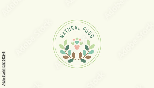 Natural food emblem design with a circular green frame enclosing leafy branches and small colorful pastel hearts.