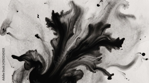 Dramatic black ink explosion on white surface with abstract fluid art texture and high contrast