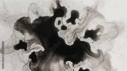 Abstract black ink diffusion in water creating dramatic monochrome patterns and textures