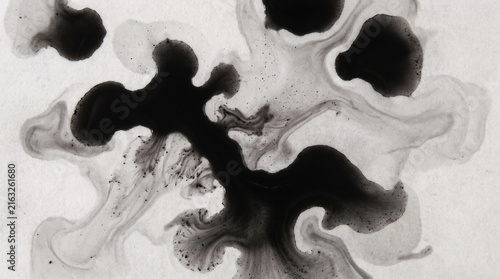 Abstract black ink splatter texture on white background for modern design and art projects