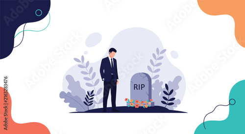 Mourning man in dark business suit standing in grief before a cemetery tombstone with colorful funeral flowers.