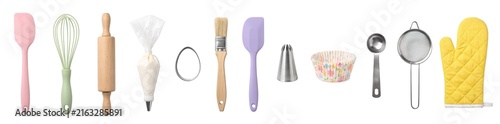 Baking tools for Easter are arranged on a white surface. The set includes a whisk, rolling pin, spatula, and more. These tools help make treats for the holiday