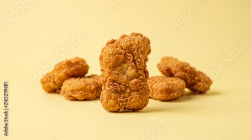 Crispy Breaded Fried Chicken Nuggets Group on Yellow Background