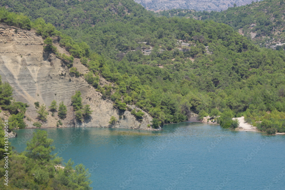Obraz premium Scenic River Lake Landscape with Green Hills for Hiking Camping Tourism and Boating