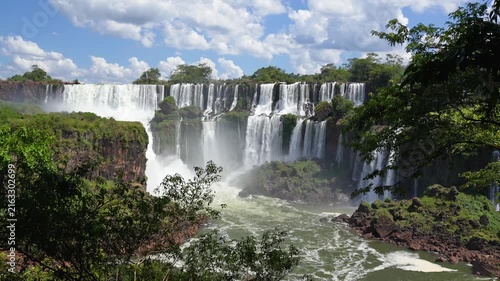 Powerful multi-tiered cascades of the Iguazu Falls in South America, flowing into a misty gorge. A breathtaking landscape of the jungle wilderness