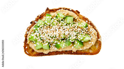 Fotografie Toasted whole grain bread slice with hummus diced cucumber and sesame seeds, iso
