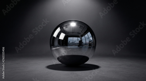 Shiny reflective metal sphere on dark surface