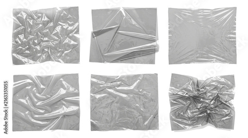 Crumpled transparent plastic wrap sheets with various crinkled textures and folded glossy edges arranged in a professional collection isolated for graphic design usage on transparent background.