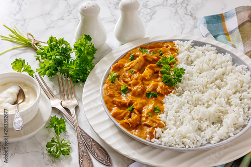 Butter chicken with fluffy basmati rice on plate
