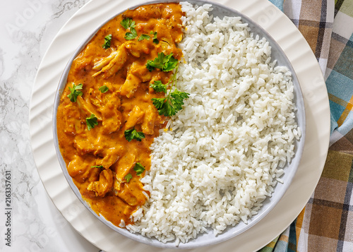 Butter chicken with fluffy basmati rice on plate