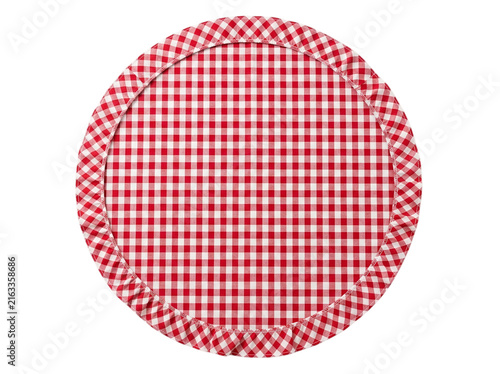 A round red and white checkered fabric placemat with a ruffled edge shown as an isolated object on transparent background isolated on transparent background