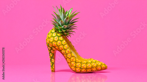 High heel shoe made of pineapple on pink background