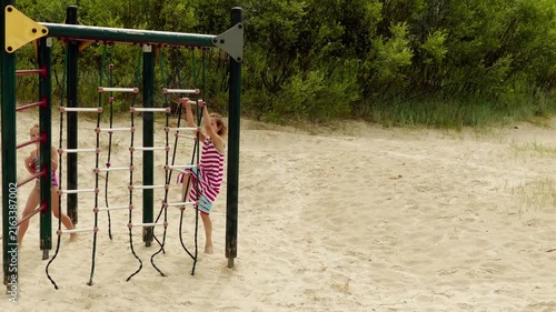 Two sisters play on a playground on the Baltic Sea in Jurmala, Latvia.