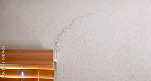 drywall (plasterboard, sheetrock) crack by bedroom window frame due to ground subsidence or movement