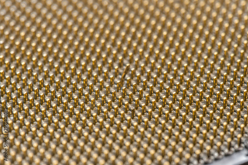 Bent contact pin among precisely aligned electronic component connections illustrating a microscopic hardware defect