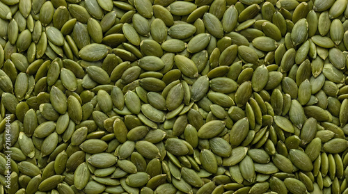 Fresh raw green pumpkin seeds texture background