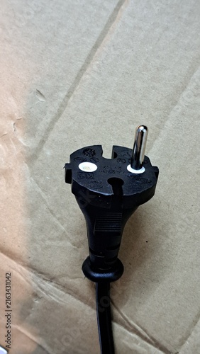 Картината върху платно Electrical plug with a defective single pin, black plastic casing, and a flexibl