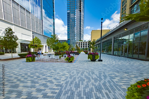 Spacious Reston plaza features patterned paving, outdoor furniture, and modern architecture.