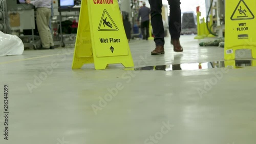 safety caution wet floor signs in a large manufacturing plant