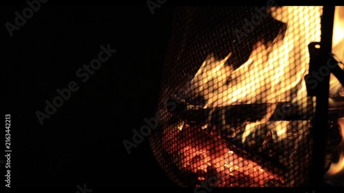 A bonfire burning red in the pitch-black night