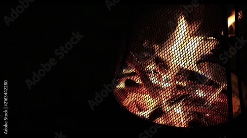 A bonfire burning red in the pitch-black night