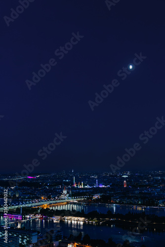 Konstfotografi Night panoramic view of illuminated Vienna cityscape and Danube river under moon
