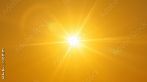 Bright Sun with Starburst Lens Flare in Vibrant Orange Sky