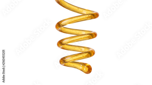 Golden honey stream drizzling in fluid spiral motion for organic food liquid packaging banner concept on transparent background