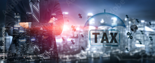 Photography Professional Businessman Overlooking Cityscape with Tax Icons and Symbols Representing Finance and Economy in Urban Environment
