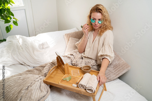 40s, anti aging, attractive, beautiful, beauty, beauty ritual, beauty treatment, bed, bedroom, beige clothes, cozy, elegant, face massage, facial care, facial roller, healthy lifestyle, healthy skin, 