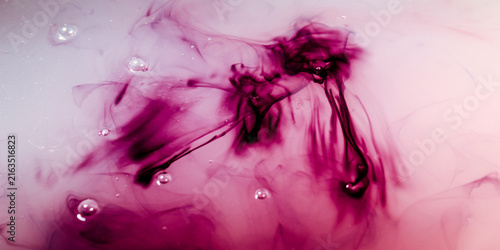 Obraz na płótnie a dark purple liquid that slowly dissolves, spreads, and swirls in a cloudy whit