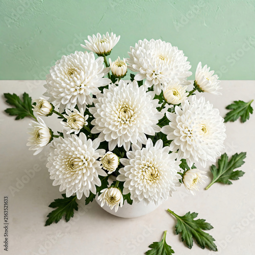 White chrysanthemum flower bouquet in vase on table top view