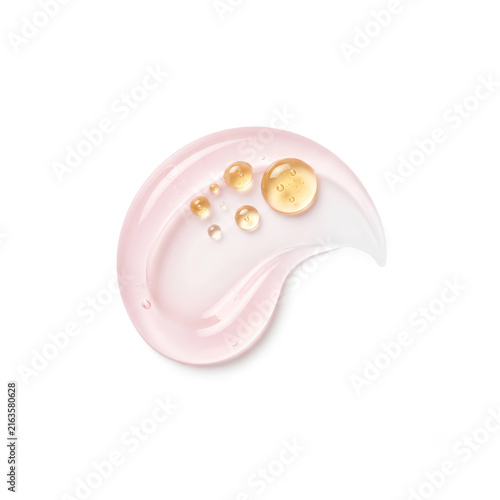 Top-down view of rosewater gel cream swirl with golden honey droplets on white background